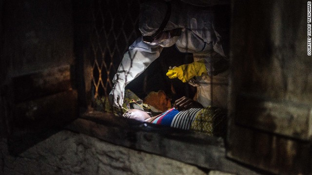 Dr. Jose Rovira of the World Health Organization takes a swab from a suspected Ebola victim in Pendembu on July 18.