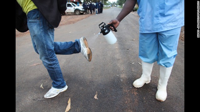 A man gets sprayed with disinfectant Sunday, August 3, in Monrovia.