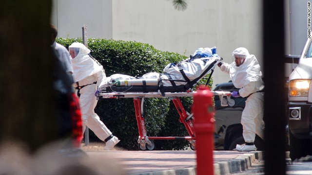 Aid worker Nancy Writebol, wearing a protective suit, gets wheeled on a gurney into Emory University Hospital in Atlanta on August 5. A medical plane flew Writebol from Liberia to the United States after she and her colleague Dr. Kent Brantly were infected with the Ebola virus in the West African country. 