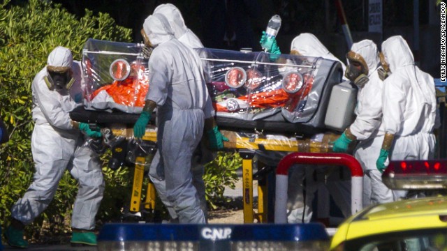Paramedics in protective suits move Pajares, the infected Spanish priest, at Carlos III Hospital in Madrid on Thursday, August 7. He died five days later.