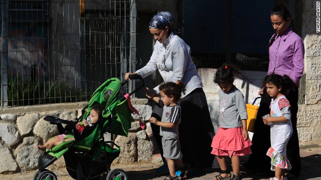 Israelis flee after a rocket fired from Gaza hit the residential neighborhood of Sderot, Israel, on August 8.