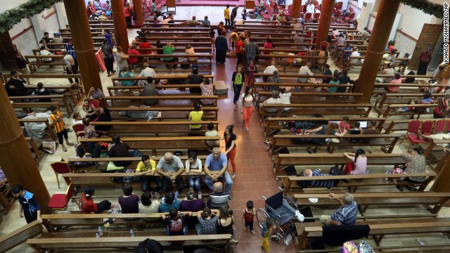 Displaced Iraqi Christians settle at St. Joseph Church in Irbil on Thursday, August 7.