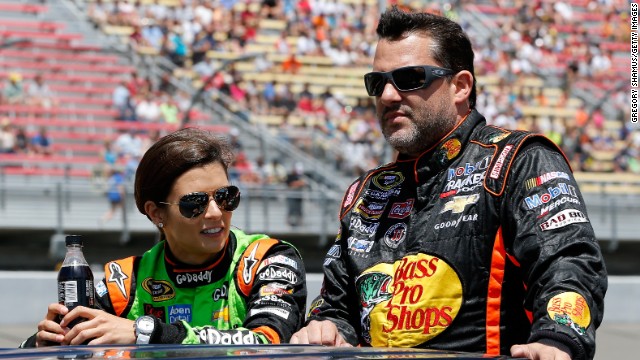 Danica Patrick and Stewart ride down pit road before the NASCAR Sprint Cup Series Quicken Loans 400 at Michigan International Speedway on June 15 in Brooklyn, Michigan. 