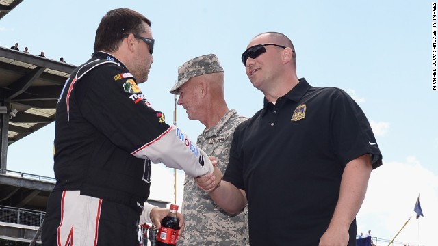 Stewart shakes hands with Gunnery Sgt. Samuel Deeds at the Indianapolis Motor Speedway on July 28. As winner of the annual Crown Royal "Your Hero's Name Here" program, Deeds received naming rights to the July 28 NASCAR Sprint Cup Series race at the Brickyard.