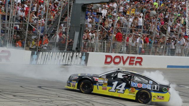 Stewart celebrates with a burnout after winning the NASCAR Sprint Cup Series FedEx 400 at Dover International Speedway on June 2, 2013, in Dover, Delaware. 