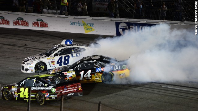 Stewart, in car 14, spins out along with Jimmie Johnson, in car 48, after an on-track incident during the NASCAR Sprint Cup Series Toyota Owners 400 at Richmond International Raceway on April 27, 2013, in Richmond, Virginia. 