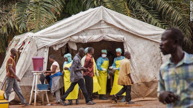 Health workers in Kenema, Sierra Leone, screen people for the Ebola virus on Saturday, August 9, before they enter the Kenema Government Hospital.