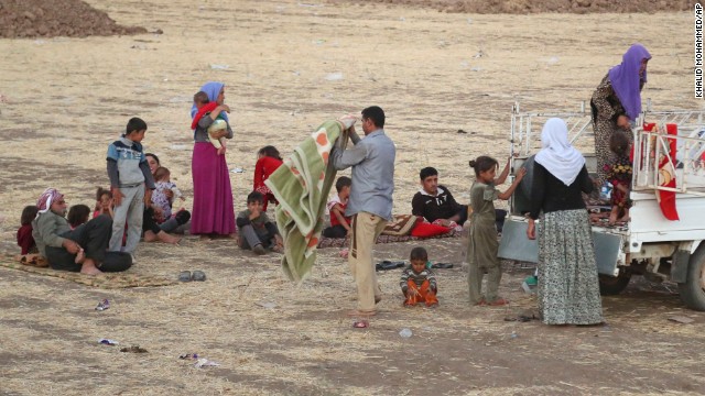 Displaced Iraqis from the Yazidi community settle outside the Bajid Kandala camp on Saturday, August 9.