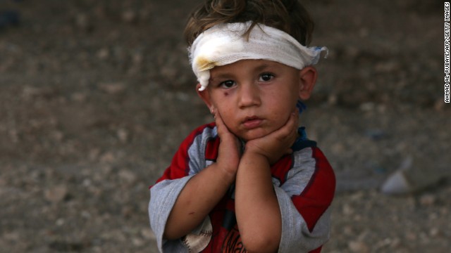 An Iraqi Yazidi child, whose family fled their home a week ago when ISIS militants attacked their town, looks on at a makeshift shelter August 10 in Dohuk, which is in Iraq's autonomous Kurdistan region.