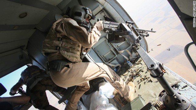 An Iraqi gunner opens fire at possible ISIS targets during a rescue operation by the Iraqi Air Force and Kurdish Peshmerga fighters on Monday, August 11. The dramatic operation at Iraq's Mount Sinjar involved taking supplies to desperate Yazidis and even bringing some aboard a helicopter to make it safely out of the area.