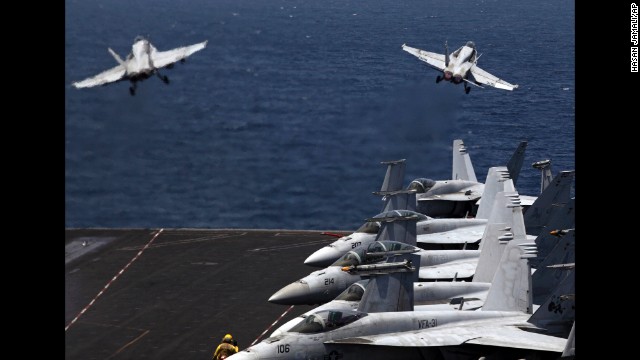 From the flight deck of the USS George H.W. Bush, which is in the Persian Gulf, two U.S. fighter jets take off for a mission in Iraq on Monday, August 11. U.S. President Barack Obama has authorized airstrikes against Islamic militants and food drops for Iraqis who are trapped by the militants.