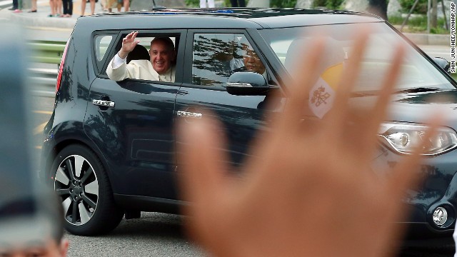Pope Francis waves to a crowd after his arrival in Seongnam, South Korea, on August 14.