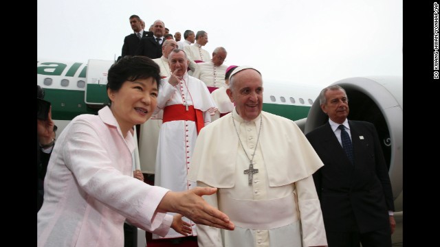 Pope Francis is escorted by Park upon his arrival at Seoul Military Airport in Seongnam.