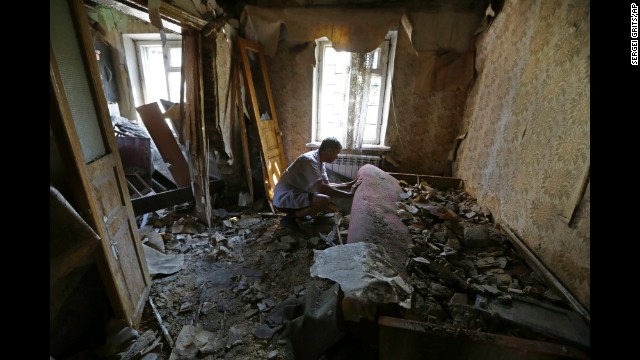 A man inspects damage at his house after a shelling in Donetsk on August 14. 