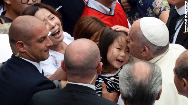 The Pope kisses a child at the Mass of the Assumption of Mary at Daejeon World Cup stadium in Daejeon, South Korea, on August 15.
