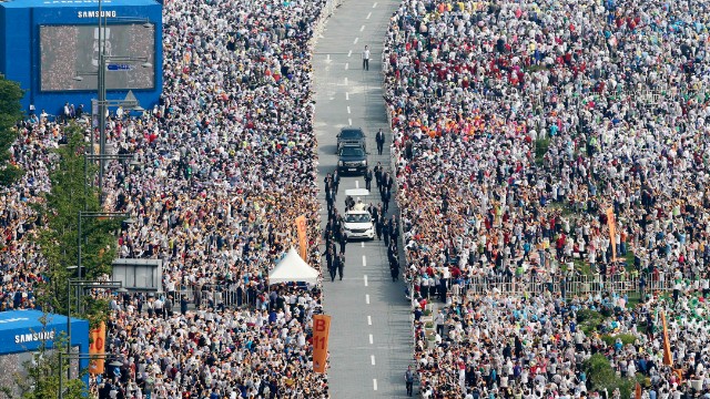 Thousands of people line a street as Pope Francis arrives for a Mass to beatify Korean martyrs on August 16.