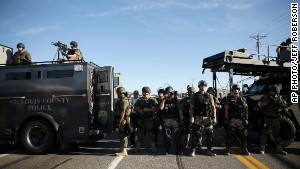 Police in riot gear watch protesters in Ferguson, Missouri, on Wednesday.