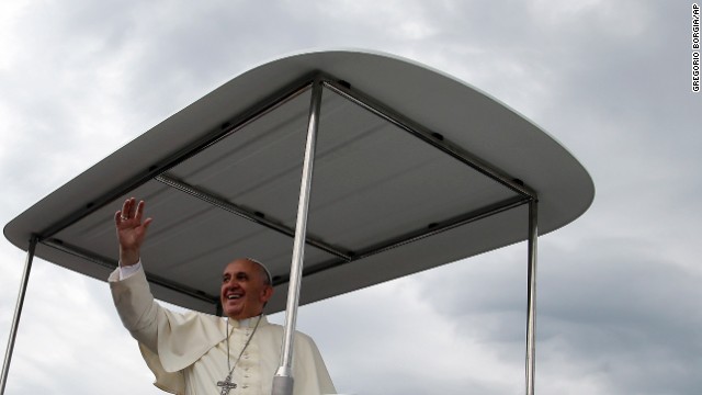 Pope Francis blesses the faithful on August 17 as he arrives for Mass. 