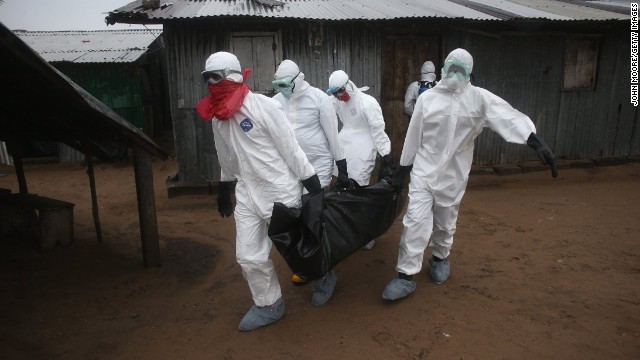 A burial team wearing protective clothing retrieves the body of a 60-year-old Ebola victim from his home near Monrovia on Sunday, August 17. 