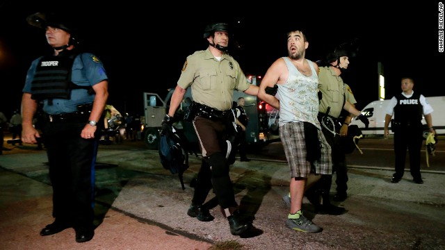 Police lead a man away during a protest August 18.