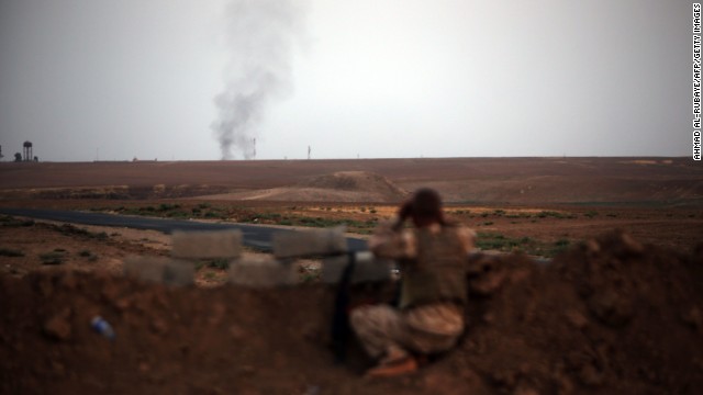 A fighter with Kurdish Peshmerga forces battles ISIS militants near Mosul, Iraq, on Monday, August 18.