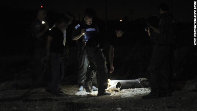 Police examine the remains of a rocket launched from Gaza that landed near the kibbutz of Yad Mordechay on August 19.