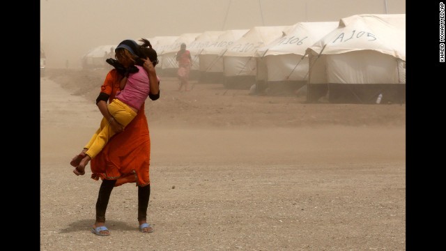 A woman holds her sister during a sandstorm at a refugee camp in Feeshkhabour on August 19.