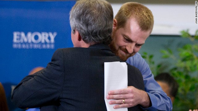 Ebola survivor Dr. Kent Brantly, right, hugs a member of the Emory University Hospital staff after being released from treatment in Atlanta on August 21. 