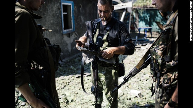 A pro-Russian rebel holds shrapnel from a rocket after shelling in Donetsk, Ukraine, on August 22.