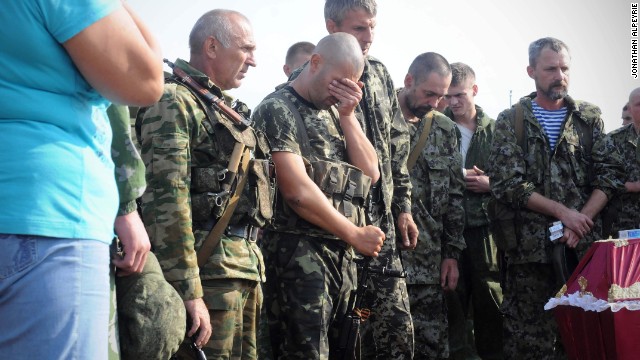 Photojournalist Jonathan Alpeyrie took a series of images of pro-Russian rebels burying four fallen fighters in Ukraine, August 18.