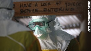 A Medecins sans Frontieres worker prepares to enter a high-risk area of an Ebola treatment center in Liberia.