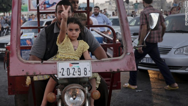 AUGUST 27 - GAZA: A little girl flashes a victory sign as Palestinians in Gaza celebrate the truce with Israel. After more than seven weeks of heavy fighting, <a href='http://edition.preview.cnn.com/2014/08/27/world/meast/mideast-crisis/index.html?hpt=hp_t2' _fcksavedurl='http://edition.preview.cnn.com/2014/08/27/world/meast/mideast-crisis/index.html?hpt=hp_t2'>the two sides have agreed to an open-ended ceasefire</a>.