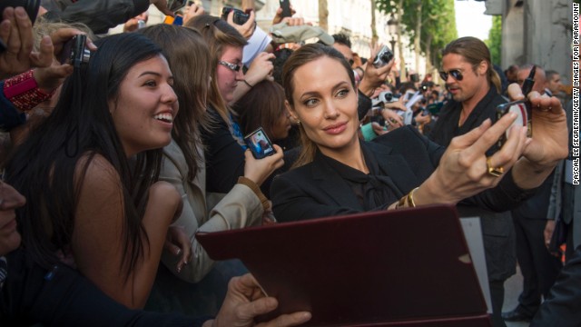 Jolie takes a selfie with fans at the premiere of Pitt's "World War Z" in Paris in June 2013.