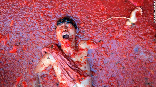 AUGUST 28 - BUNOLA, SPAIN: A man lies in a puddle of squashed tomatoes, during the annual 