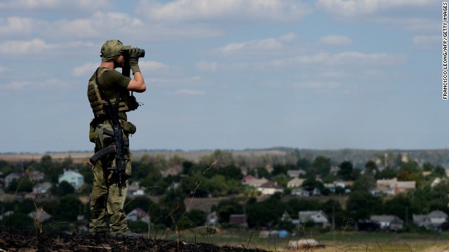 A Ukrainian loyalist fighter from the Azov Battalion stands guard on a hill on the outskirts of Mariupol on August 30.