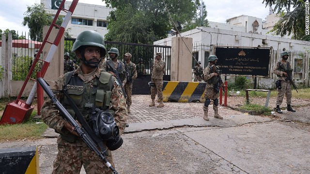 Soldiers stand guard outside the headquarters of state-owned Pakistani Television (PTV) on September 1.