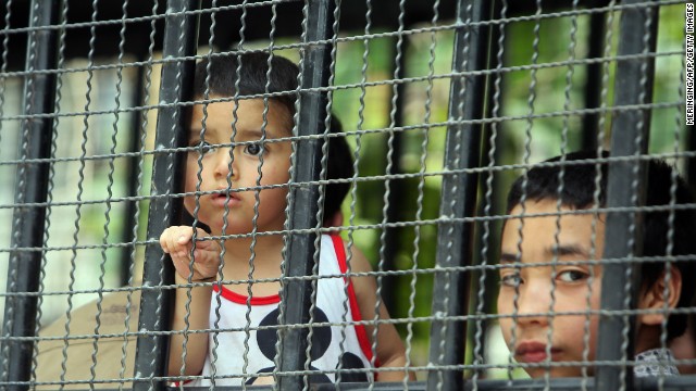 Asylum seekers, including children, are transported by immigration officials to a court in southern Thailand on March 15.