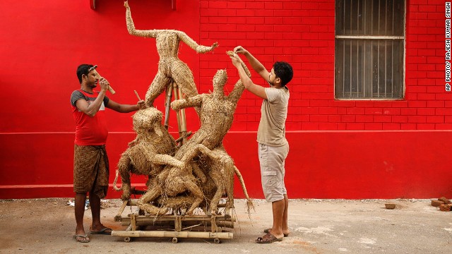 SEPTEMBER 3 - ALLAHABAD, INDIA: Indian artisans prepare an idol of the Hindu goddess Durga slaying the demon Asura for the upcoming Durga Puja festival -- <a href='http://timesofindia.indiatimes.com/life-style/fashion/trends/Fashion-forward-for-the-Durga-Puja-season/articleshow/41617906.cms' _fcksavedurl='http://timesofindia.indiatimes.com/life-style/fashion/trends/Fashion-forward-for-the-Durga-Puja-season/articleshow/41617906.cms' target='_blank'>Bengal's biggest event of the year.</a>