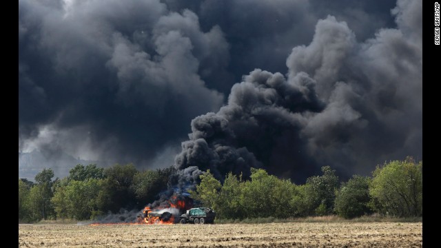 Unmarked military vehicles burn on a country road in Berezove, Ukraine, on Thursday, September 4, after a clash between Ukrainian troops and pro-Russian rebels. For months, Ukrainian government forces have been fighting the rebels near Ukraine's eastern border with Russia. The fighting has left more than 2,500 people dead since mid-April, according to the United Nations.