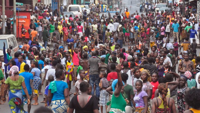 Crowds cheer and celebrate in the streets Saturday, August 30, after Liberian authorities reopened the West Point slum in Monrovia. The military had been enforcing a quarantine on West Point, fearing a spread of the Ebola virus.