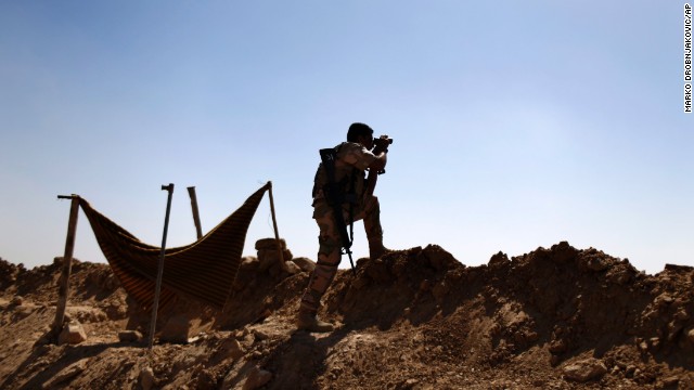 A Kurdish fighter eyes ISIS positions outside Makhmour, Iraq, on Saturday, September 6. Iraqi forces, aided by U.S. military airstrikes, have begun to make gains against terror group ISIS, which calls itself the Islamic State.