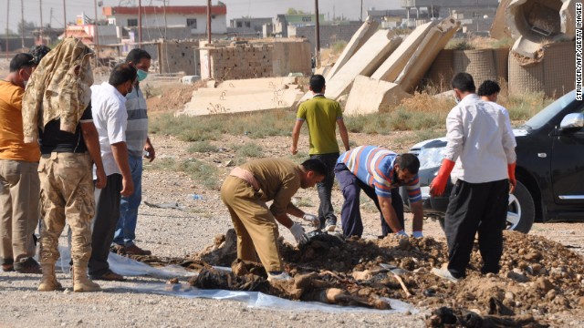 Iraqis on Friday, September 5, exhume the remains of bodies from a mass grave found after Iraqi Kurdish forces and Shiite militiamen retook the town of Sulaiman Bek from jihadists.