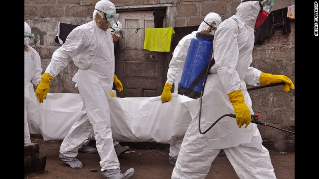 Health workers on Wednesday, September 10, carry the body of a woman who they suspect died from the Ebola virus in Monrovia.