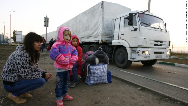 Lorries, part of a Russian humanitarian convoy, cross the Ukrainian border on September 13, 2014.