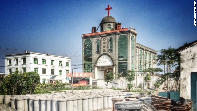 A red cross stands on top of a gray Christian church in Pingyang County in Wenzhou. Local faithful have guarded the church compound for more than two months after officials ordered the removal of the cross.