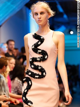 A black and white snake wraps around this pastel pink dress. 