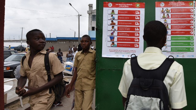 A student of the Sainte Therese school in Abidjan, Ivory Coast, looks at placards Monday, September 15, that were put up to raise awareness about the symptoms of the Ebola virus.