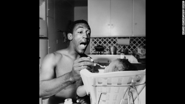 Cosby first made his name with his comedic storytelling, often based on his childhood experiences. In 2011, SPIN magazine put "To Russell, My Brother, Whom I Slept With" at the top of its "40 Greatest Comedy Albums of All Time" list. Here, Cosby feeds one of his children in the mid-1960s.
