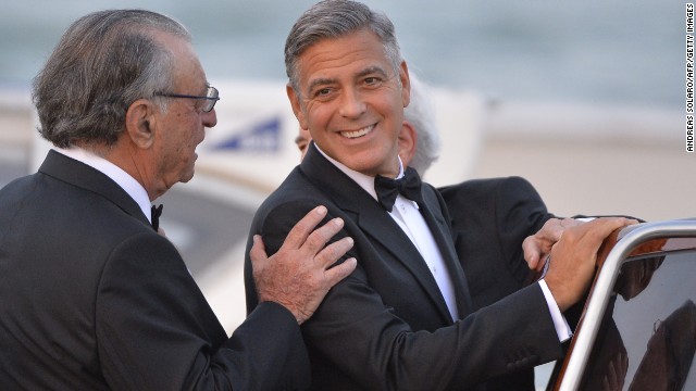 George Clooney climbs aboard a taxi boat as he leaves Hotel Cipriani in Venice, Italy, on September 27, the day of his wedding to human rights attorney Amal Alamuddin. 