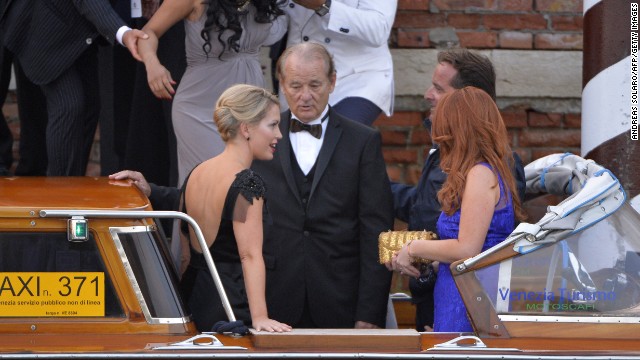 Bill Murray boards a taxi boat with other guests. 